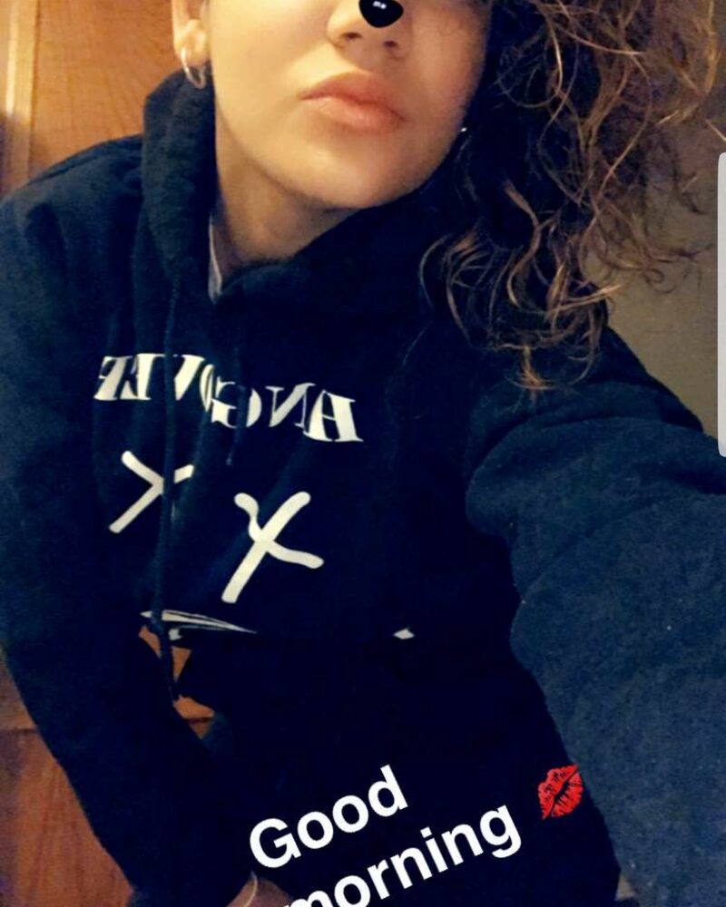 Woman with a cat-ear filter wearing a Hangover Lifestyle hoodie