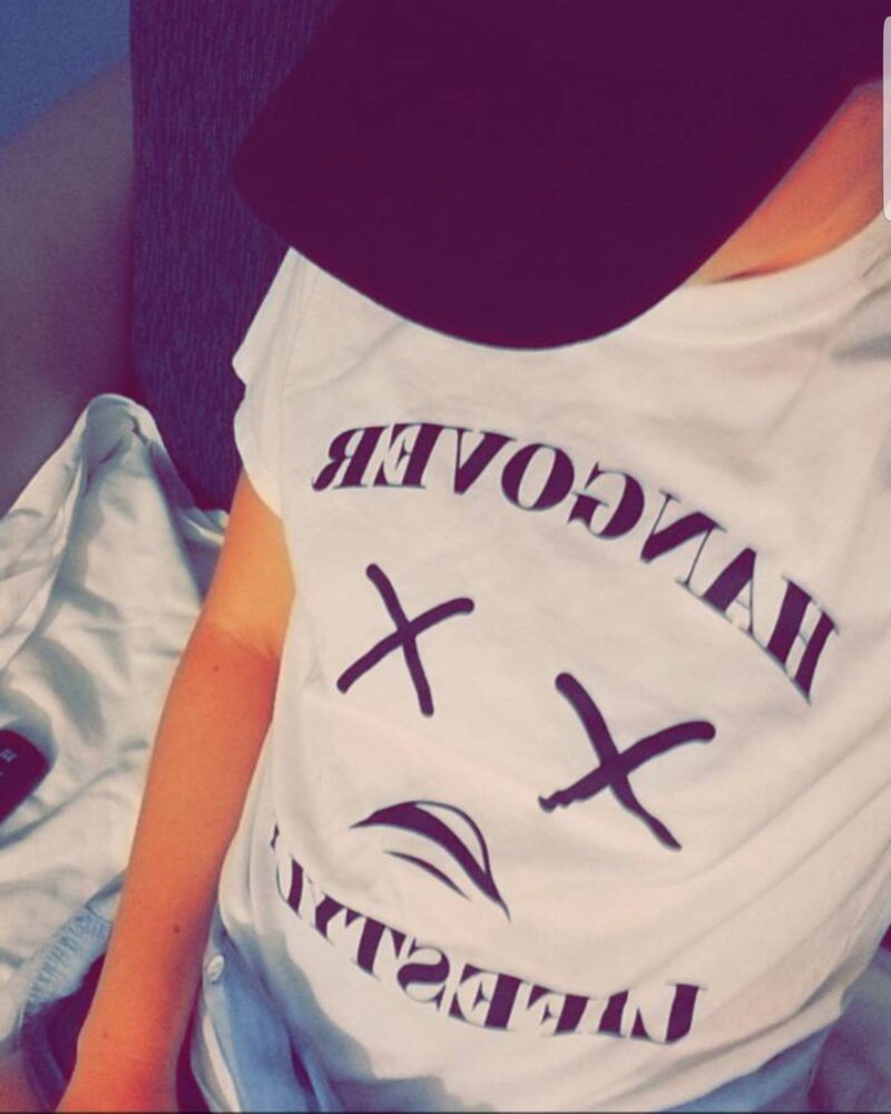 Woman in a cap wearing a Hangover Lifestyle shirt